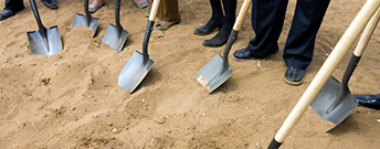 shovels in dirt breaking ground