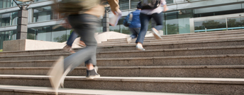Image of people walking up the stairs